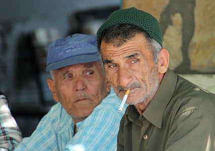 man sitting beside man at daytime thumbnail