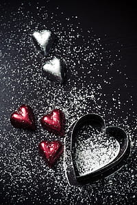five heart chocolates with confectioners sugar and molder thumbnail
