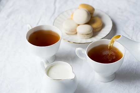 two white ceramic tea cups and white teapot thumbnail