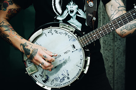 man playing white and black guitar thumbnail