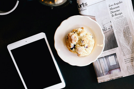 white iPad near food on white ceramic plate thumbnail