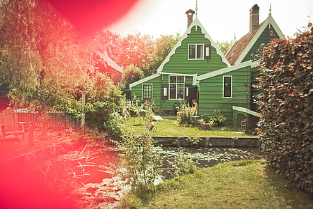green house beside pond at daytime thumbnail