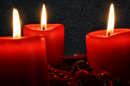 closeup photo of three lighted red candles thumbnail