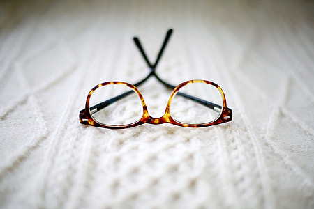 eyeglasses with brown frames on white knit textile thumbnail