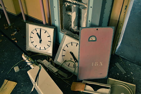 two white analog clocks on black surface thumbnail