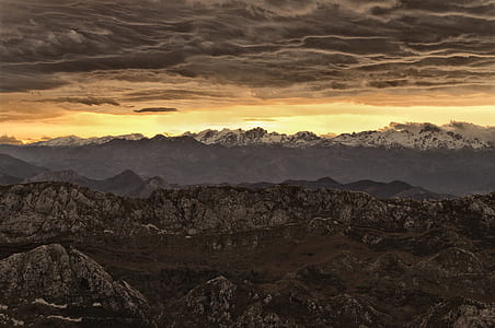 silhouette photo of mountain ranges during golden hour thumbnail