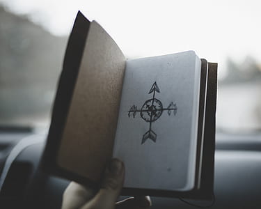 person holding black book thumbnail