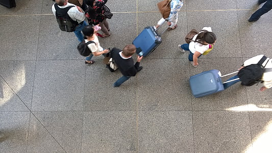 top view photography of people walking on gray tiled floor thumbnail