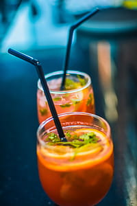 Two Beverages In Footed Glasses With Black Straws thumbnail