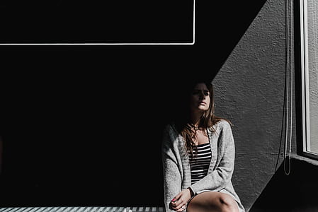 woman sitting near glass window thumbnail