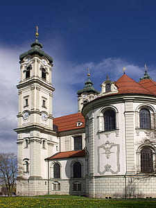 White and Orange Painted Building With Tower Near Leafless Tree Under White Clouds and Blue Sky thumbnail
