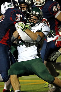 American football player toggled by other player in field thumbnail