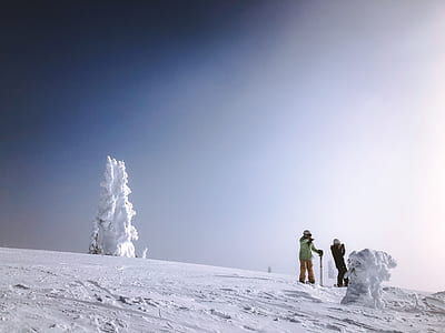 two person walking on snow covered mountain thumbnail