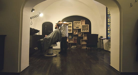 man sitting on white salon chair thumbnail