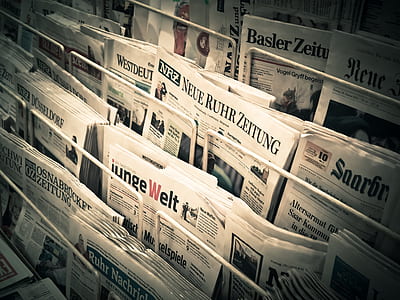 pile of newspapers on rack thumbnail