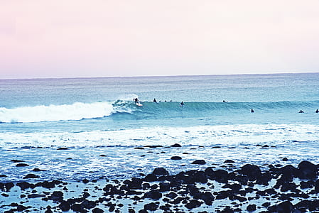 person surfing on wave of water thumbnail