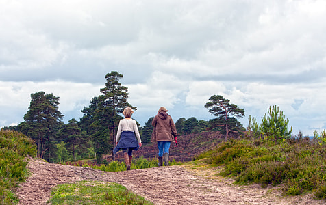 woman and man walking in a rough road during day time thumbnail