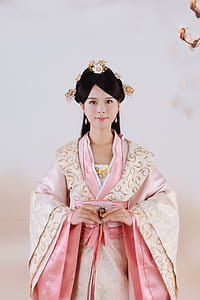 woman wearing yellow and beige kimono near white painted wall thumbnail