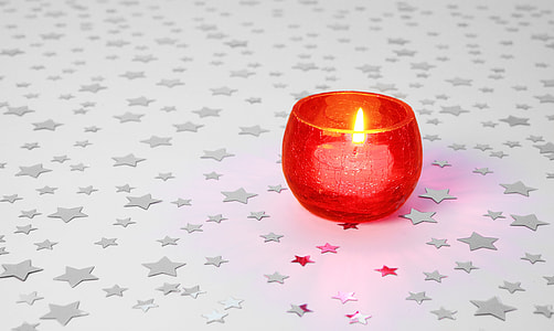 red glass candle holder on white table thumbnail