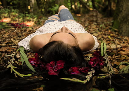 woman in white off-shoulder top lying on the grass thumbnail