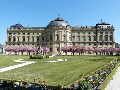 gray stone mansion with cherry orchard during day thumbnail