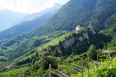 aerial photo of brown castle on top of mountain thumbnail
