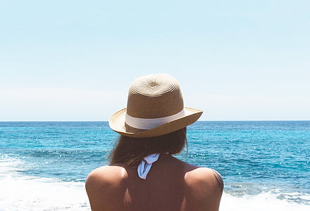 woman wearing brown straw hat at the beach thumbnail
