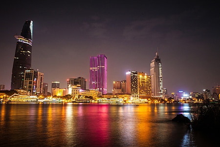 lighted high rise building beside body of water thumbnail