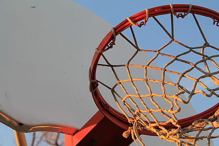 low-angle photo of red basketball hoop at daytime thumbnail