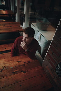 man sitting on beside table thumbnail