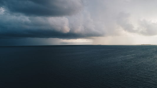 calm sea under cloudy sky thumbnail