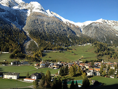 houses next to mountains covered with snow thumbnail