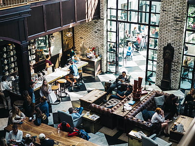 people sits inside cafeteria while holding smartphones thumbnail