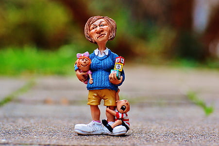 selective focus photo of ceramic woman standing holding cube figurine thumbnail