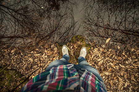man stands in leaves thumbnail