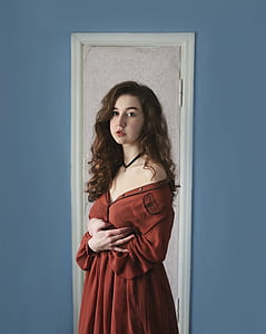 woman standing against white door thumbnail
