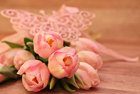 selective focus photo o fpink tulips bouquet on brown wooden surface thumbnail