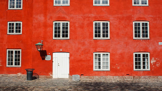 black pail beside red building thumbnail