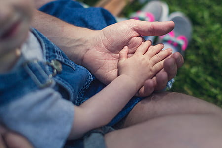 person holding childs hand thumbnail