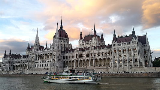 boat beside castle at daytime thumbnail