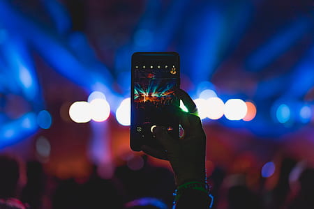 person taking a photo of an indoor stadium thumbnail