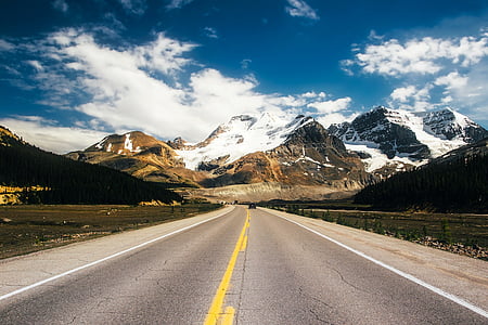 concrete road between green grass thumbnail