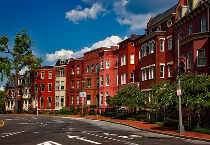 black road beside red houses thumbnail