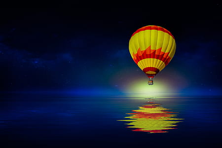 reflection of yellow and red hot air balloon on body of water thumbnail