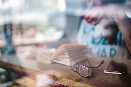 Woman reading book at coffee shop thumbnail