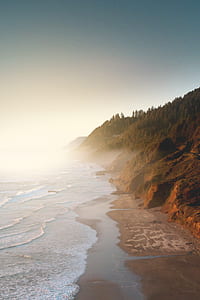 top angle photo of seashore covered with fog at daytime thumbnail