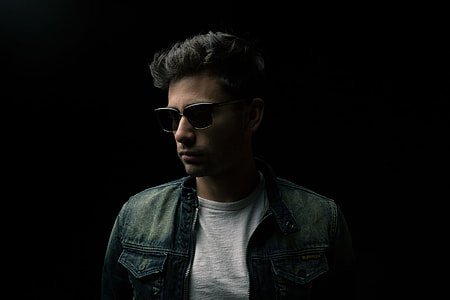 man standing on black surface wearing blue denim jacket thumbnail