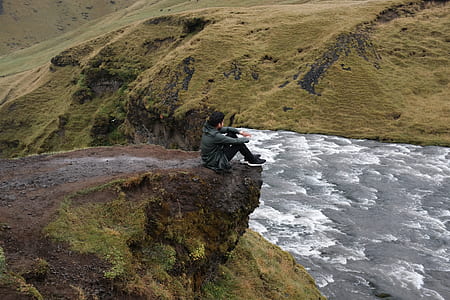 man sitting on cliff thumbnail