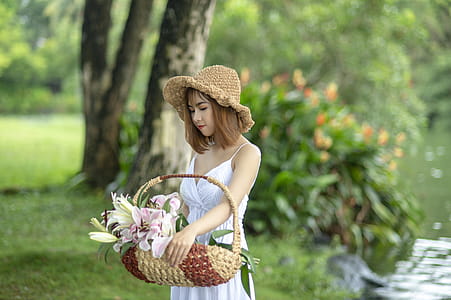 Photo of Women Carrying Basket With Pink Petal Flower thumbnail