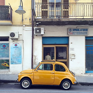 yellow car parked outside Ambulatorio building thumbnail